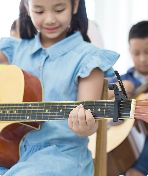 girl playing guitar while sitting chair room