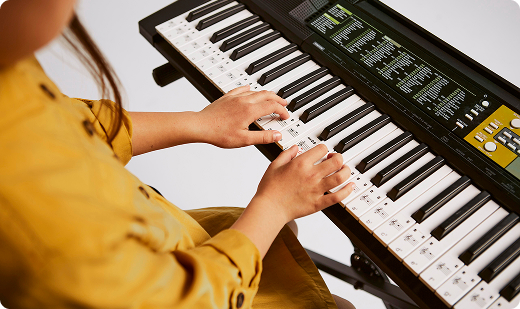 young girl learning how to play electronic keyboard home