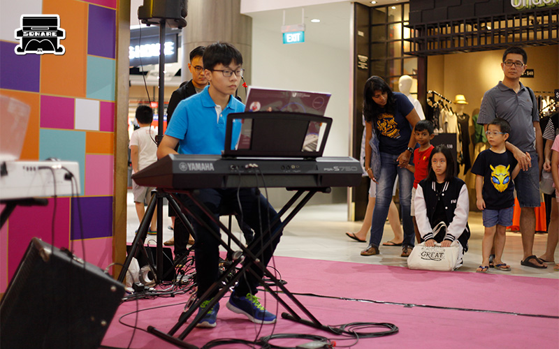 Sonare Music School student playing keyboard at performance.